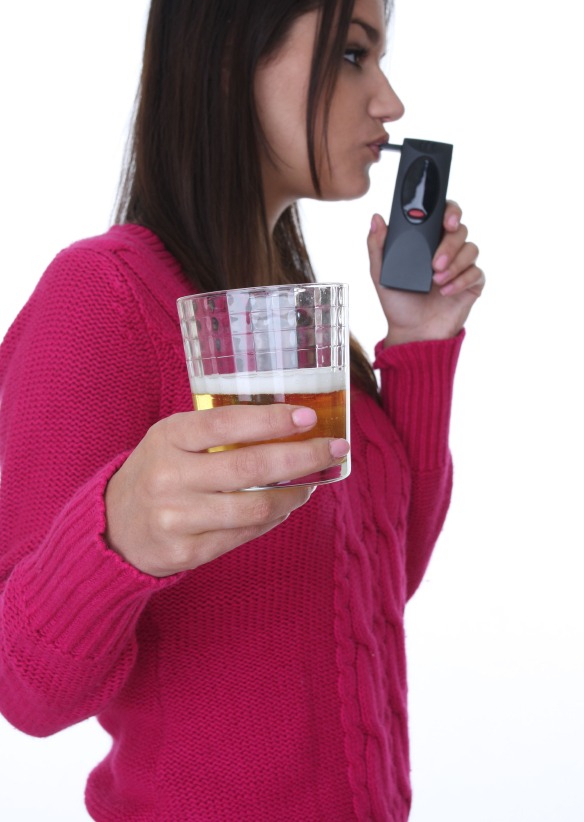 Woman taking breathalizer